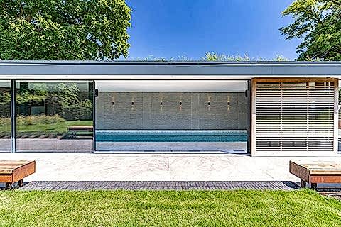 Contemprary Pool House viewed from the outside with open doors.