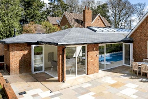 A pool extension viewed from the outside also showing the hosue it is attached to